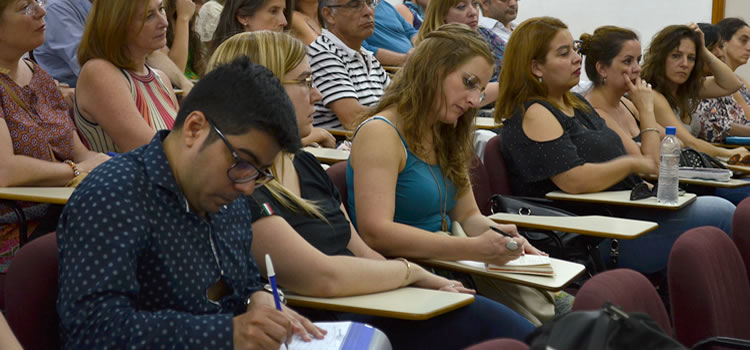 Una decena de docentes tomando notas sentados sobre pupitres